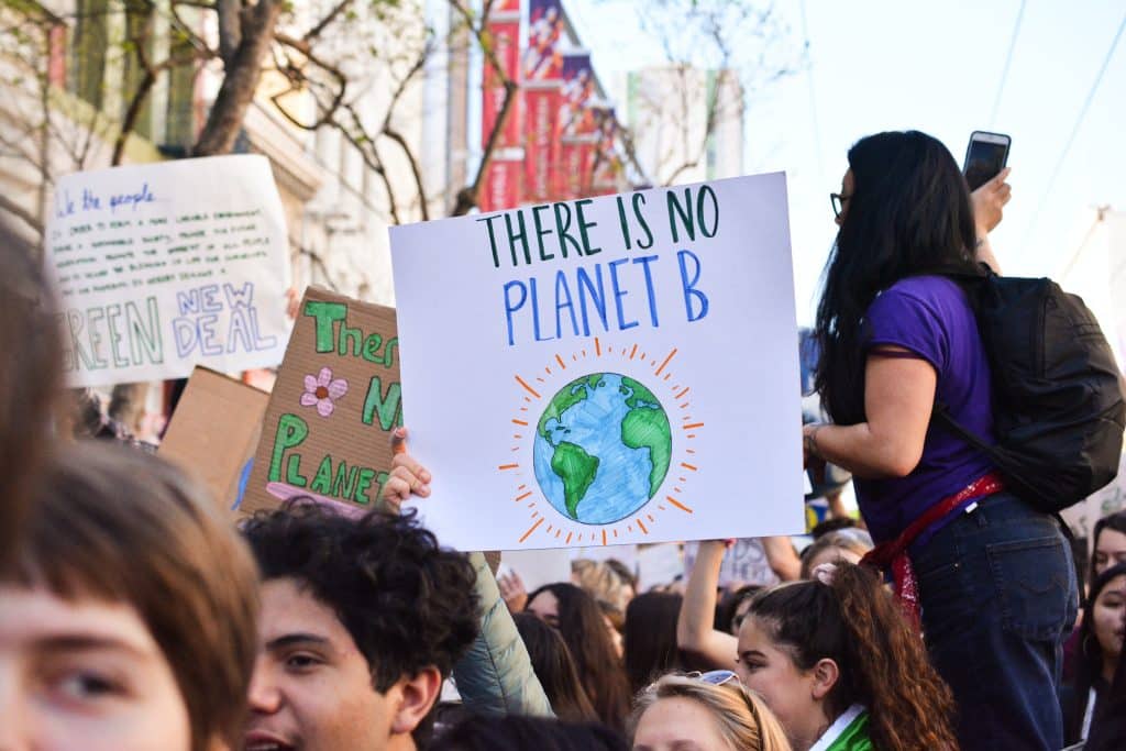protesters with placard saying there is no planet B