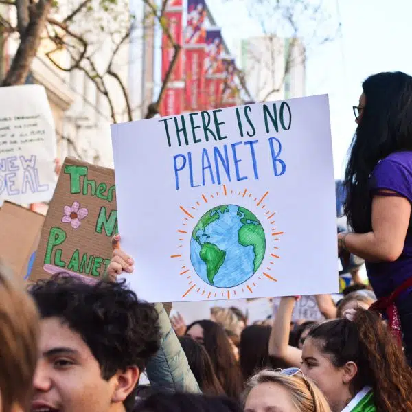 protesters with placard saying there is no planet B