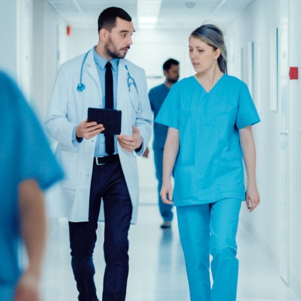 Doctors walking down a hospital corridor.