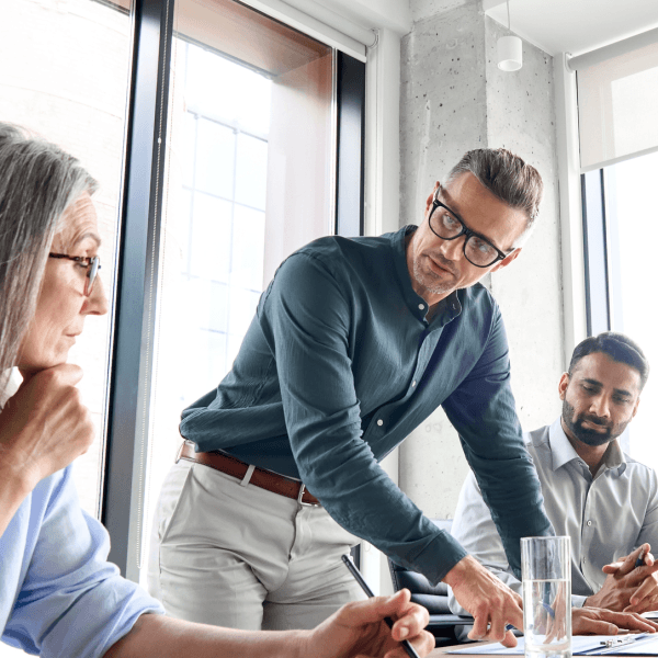 A business meeting taking place around a large table.